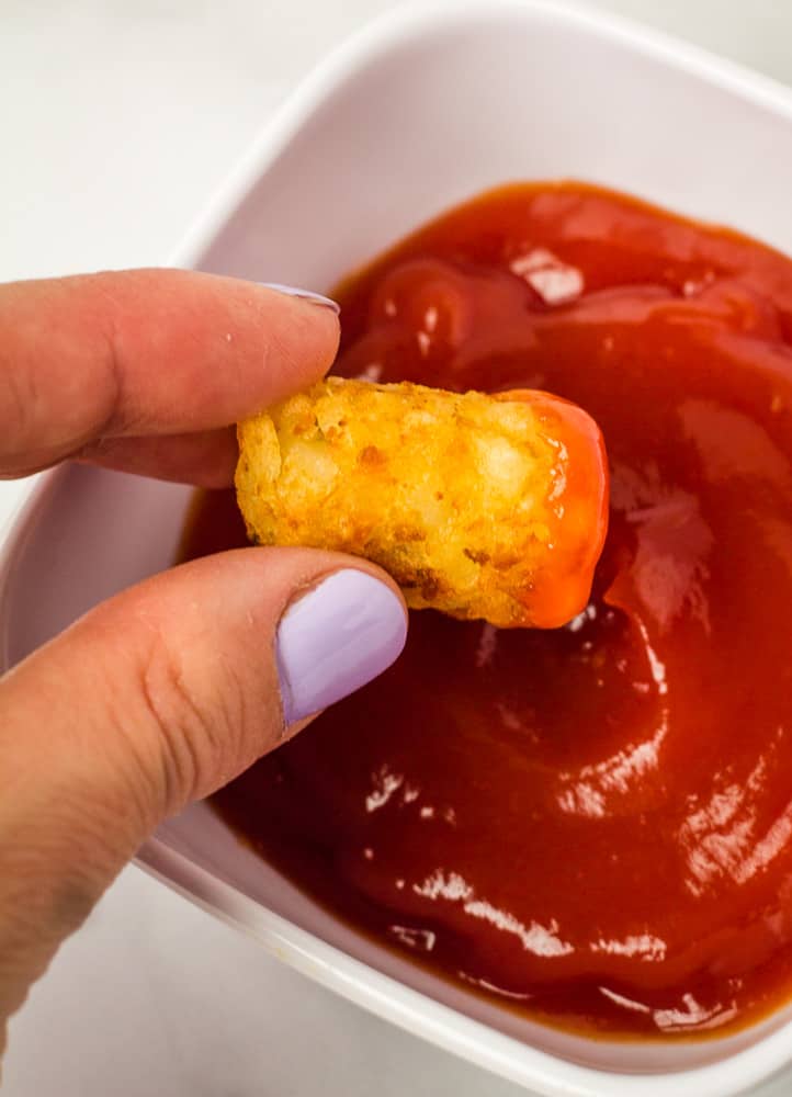 tater tot dipped in ketchup