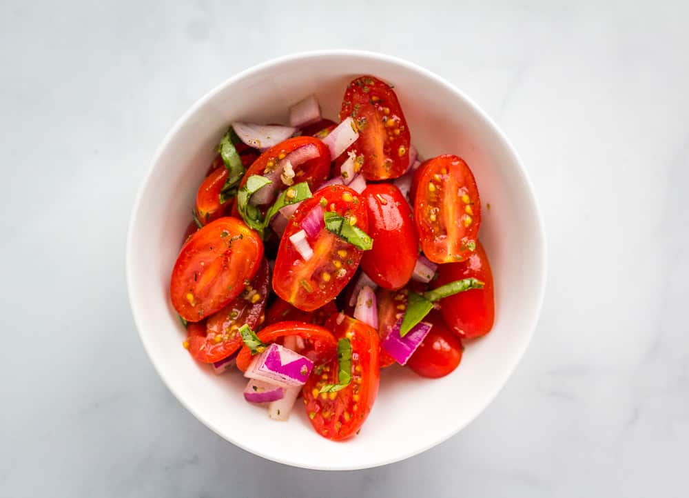 single serving of tomato salad in white bowl