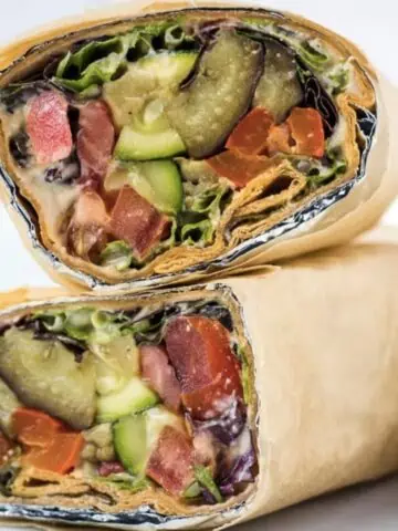 Roasted vegetable lavash wrap sandwich cut in half, and stacked.