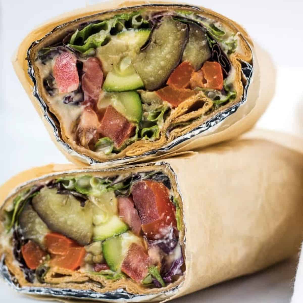 Roasted vegetable lavash wrap sandwich cut in half, and stacked.