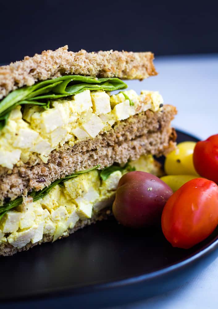 vegan egg salad sandwich with cherry tomatoes