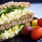 Vegan egg salad sandwich with tofu served with grape tomatoes.