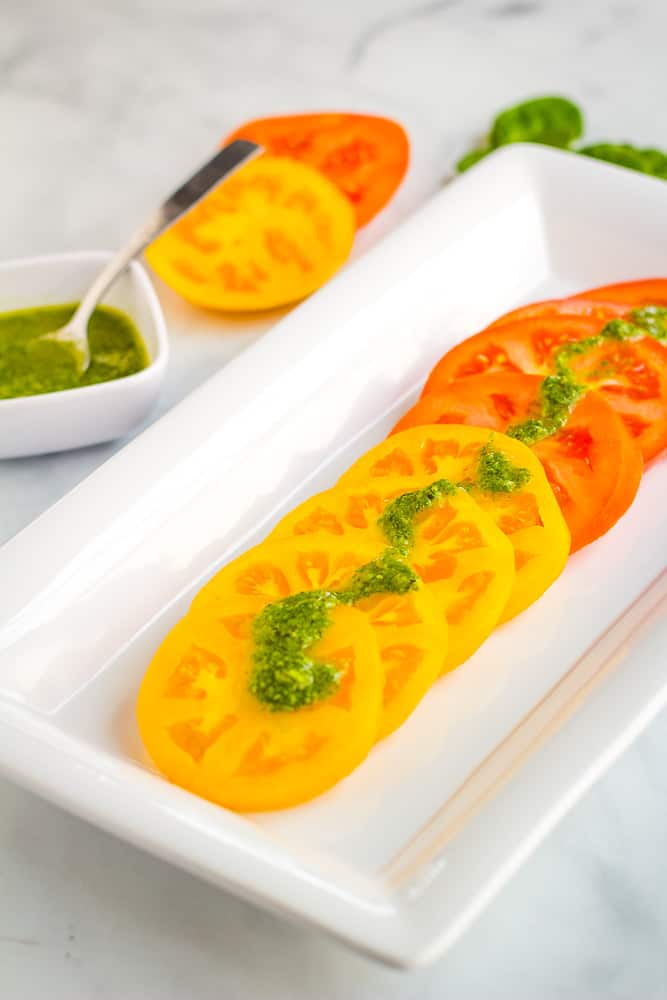 tomatoes with basil sauce over top