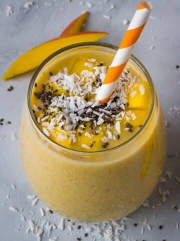 mango banana smoothie in glass with chia seed topping