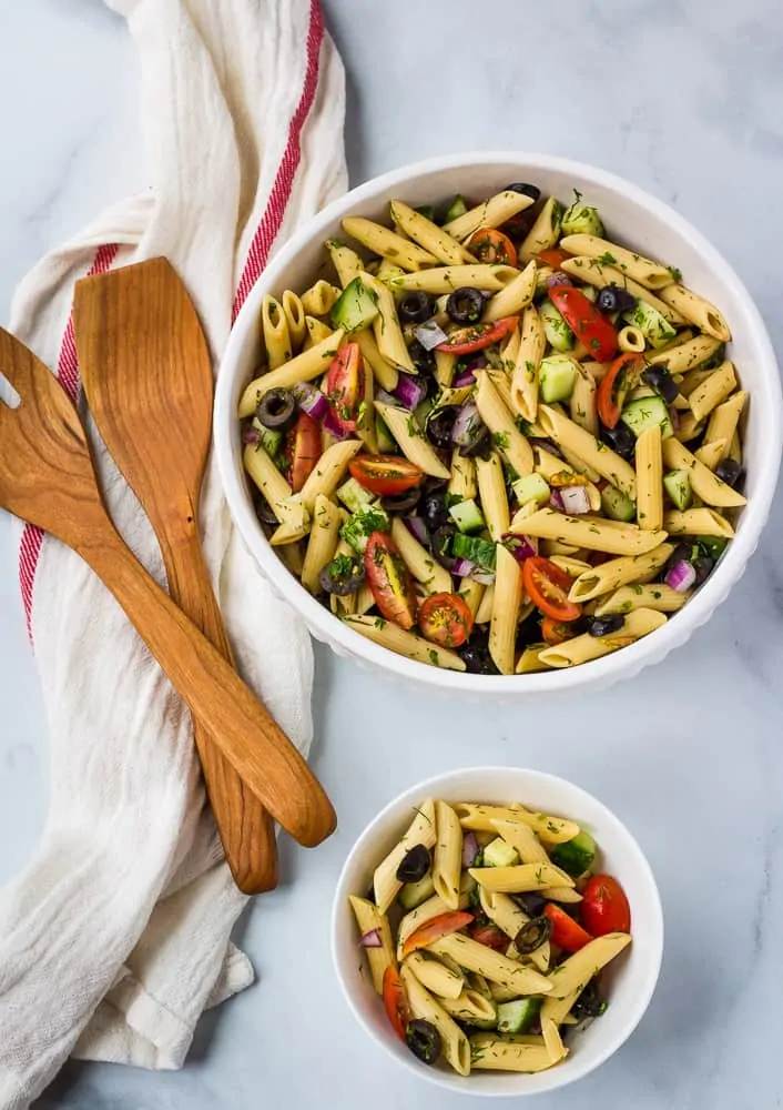 gluten free pasta salad in large white bowl and single serving bowl