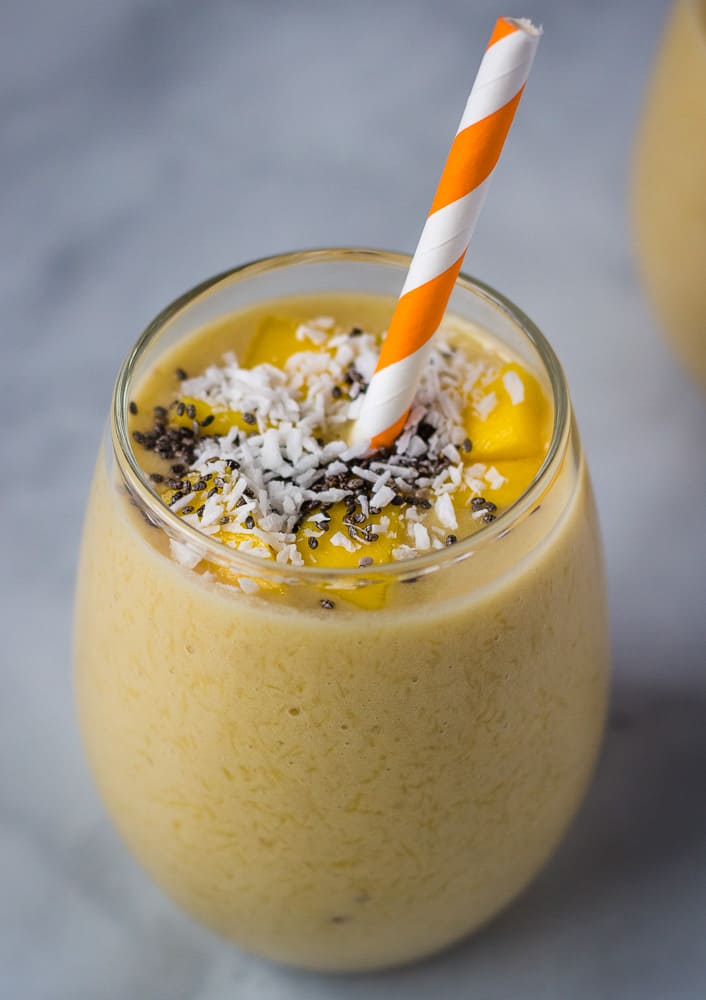 mango banana smoothie in glass cup with chia topping