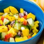 mango cucumber salad in blue bowl