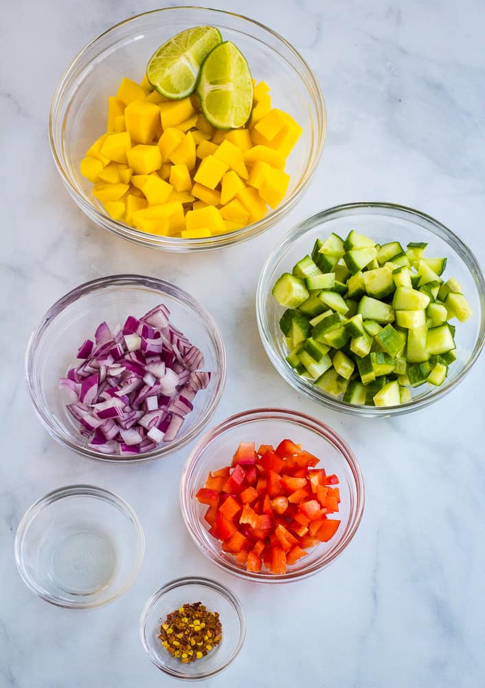 Diced mango, diced cucumber, diced red onion, diced red pepper, lime, white vinegar, and red pepper flakes.