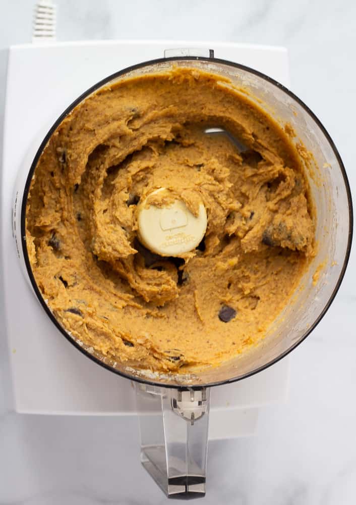 vegan blondie batter in food processor with chocolate chips