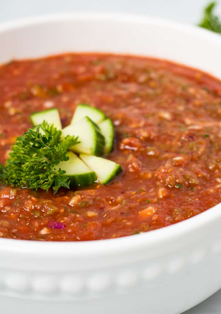 close up of gazpacho in large white bowl