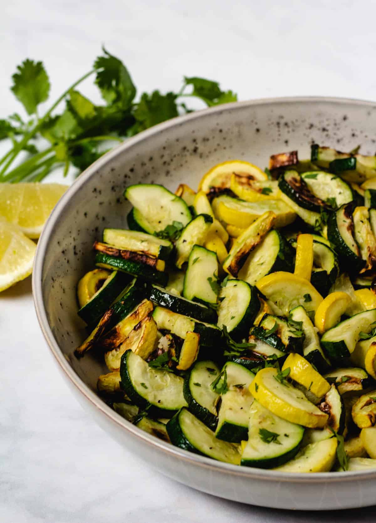 zucchini and yellow squash in gray bowl