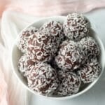 Bowl of chocolate coconut date balls.