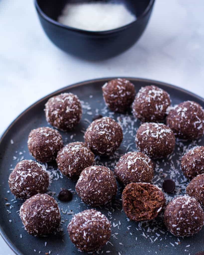 chocolate coconut date balls on gray plate