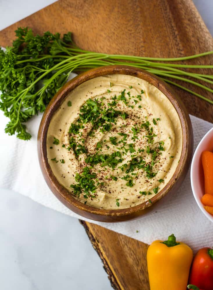 overhead of hummus with parsley