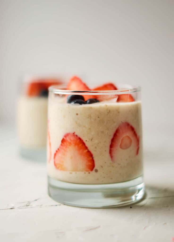 glass cup filled with oats and berries