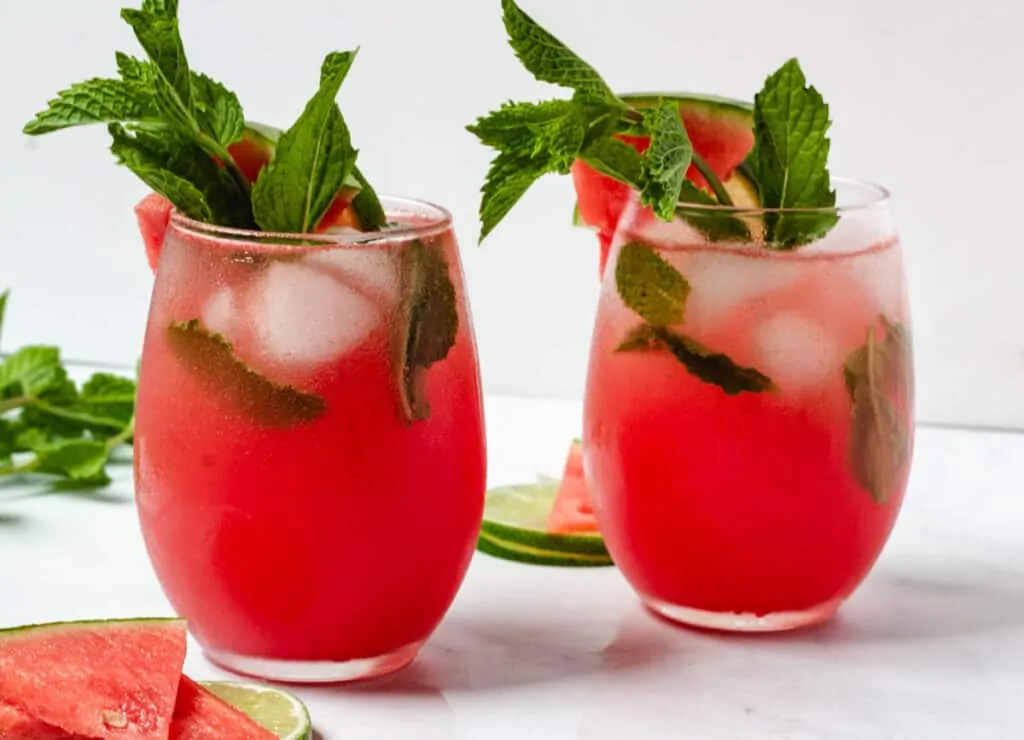 two glasses of watermlon moctails garnished with mint