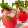 two glasses of garnished watermelon drinks