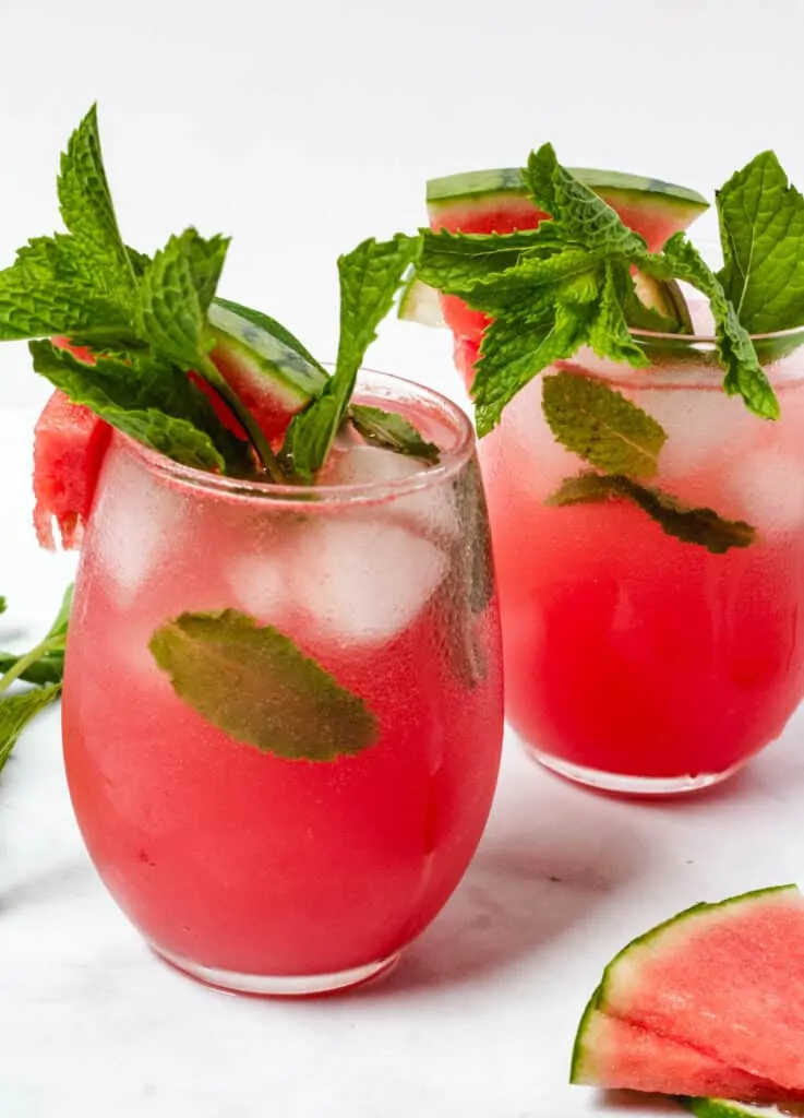 two glasses of garnished watermelon drinks