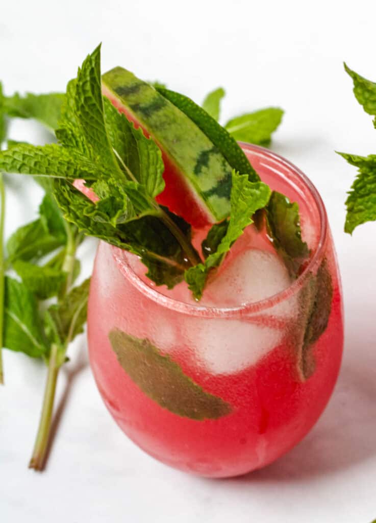 close up of watermelon drink garnished with mint