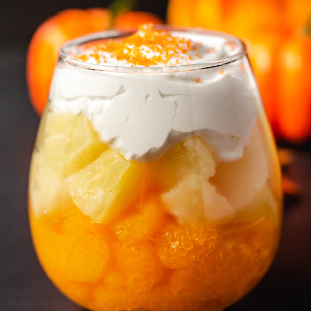 candy corn fruit parfait with mandarin oranges, pineapple, and whipped cream