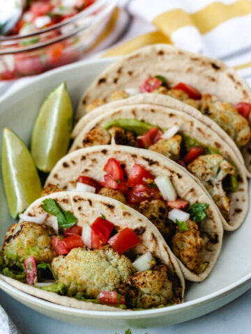 Cauliflower tacos on serving plate.