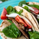vegan bao buns with mushrooms, spinach, onion, and tomato