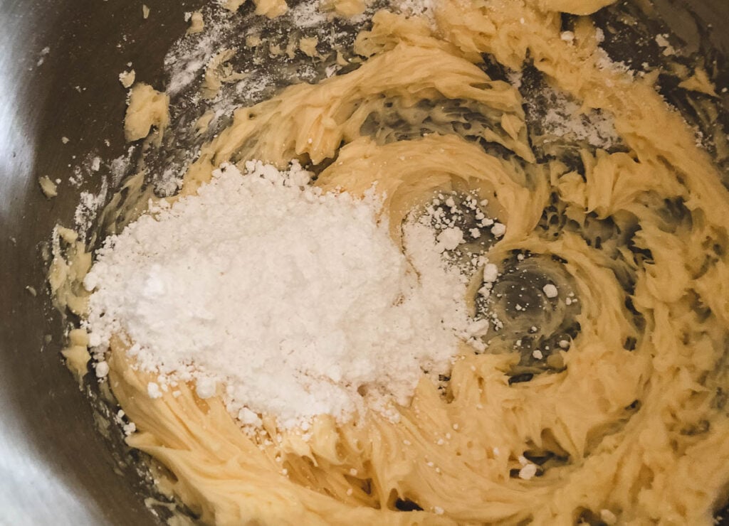 whipped butter and powdered sugar in mixing bowl