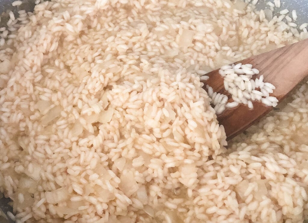 Creamy arborio rice in pot.