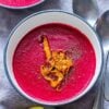 pink beet soup topped with carrots