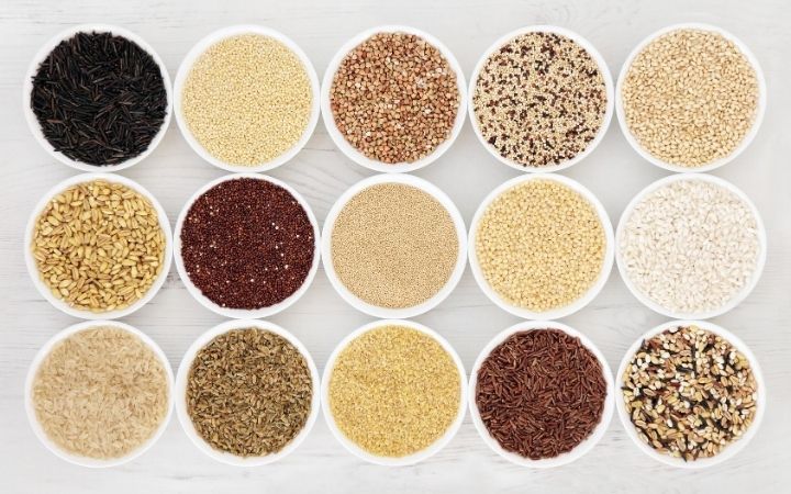 a variety of grains in small white bowls
