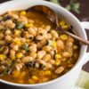 slow cooker sage and bean soup in white bowl