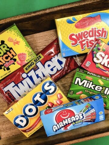 Candy on a tray: sour patch kids, swedish fish, dots, twizzlers, skittles, mike and ike, air heads.