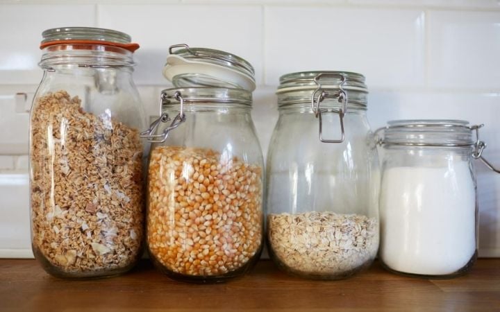 mason jars filled with granola, corn oats, and sugar