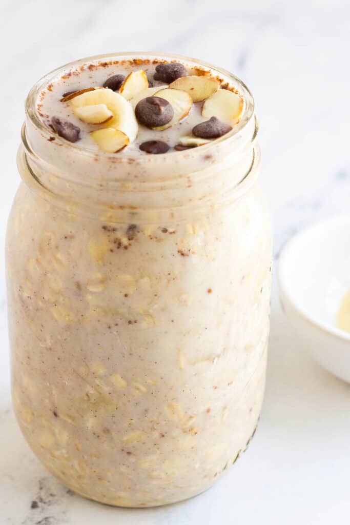 banana overnight oats topped with chocolate chips and almonds