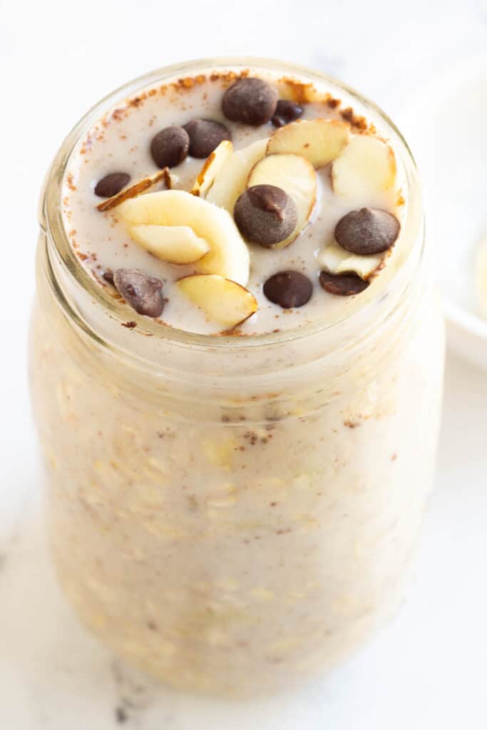 banana overnight oats topped with chocolate chips and almonds