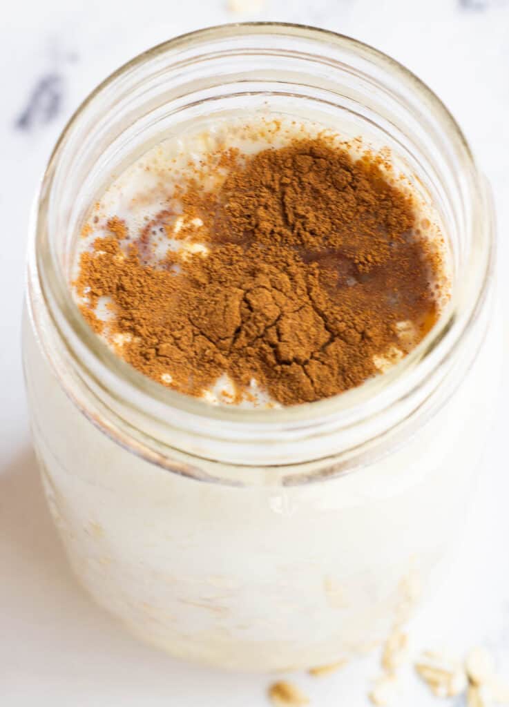 oats, milk topped with cinnamon in mason jar