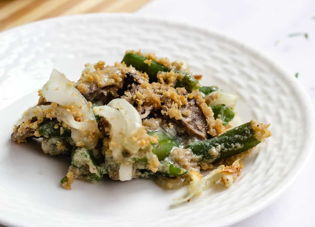 Serving of green bean casserole on white plate.