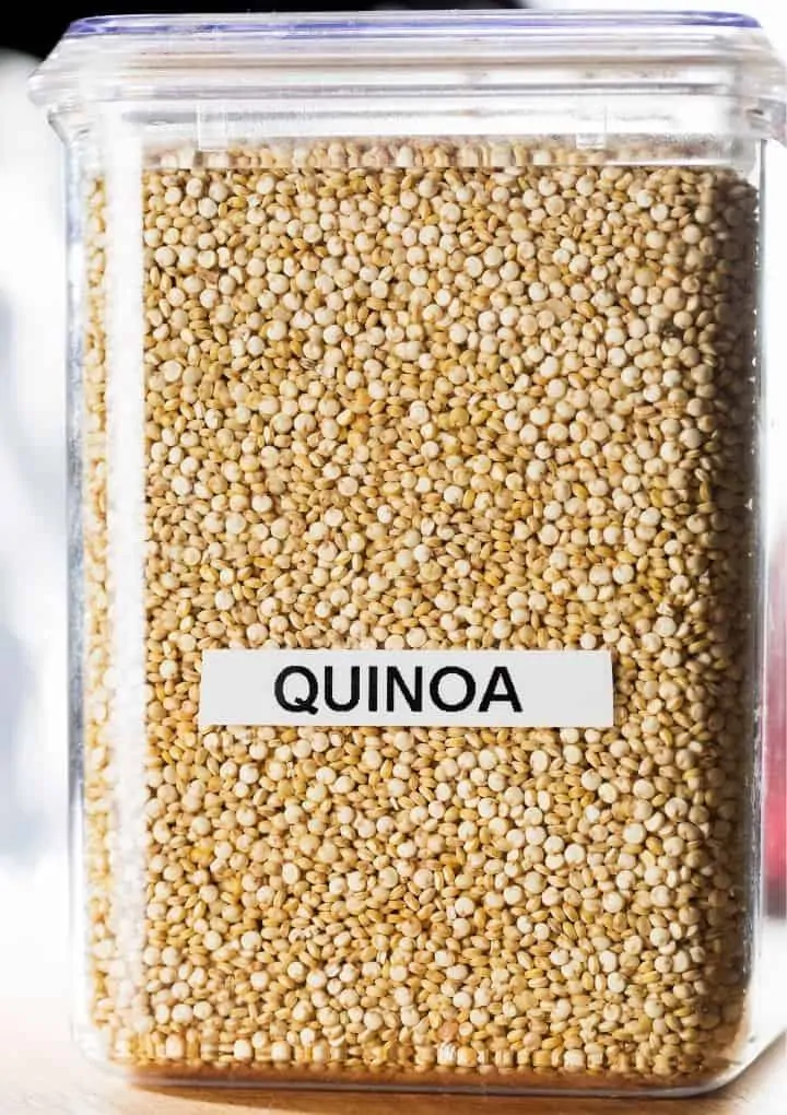 large clear container filled with white quinoa
