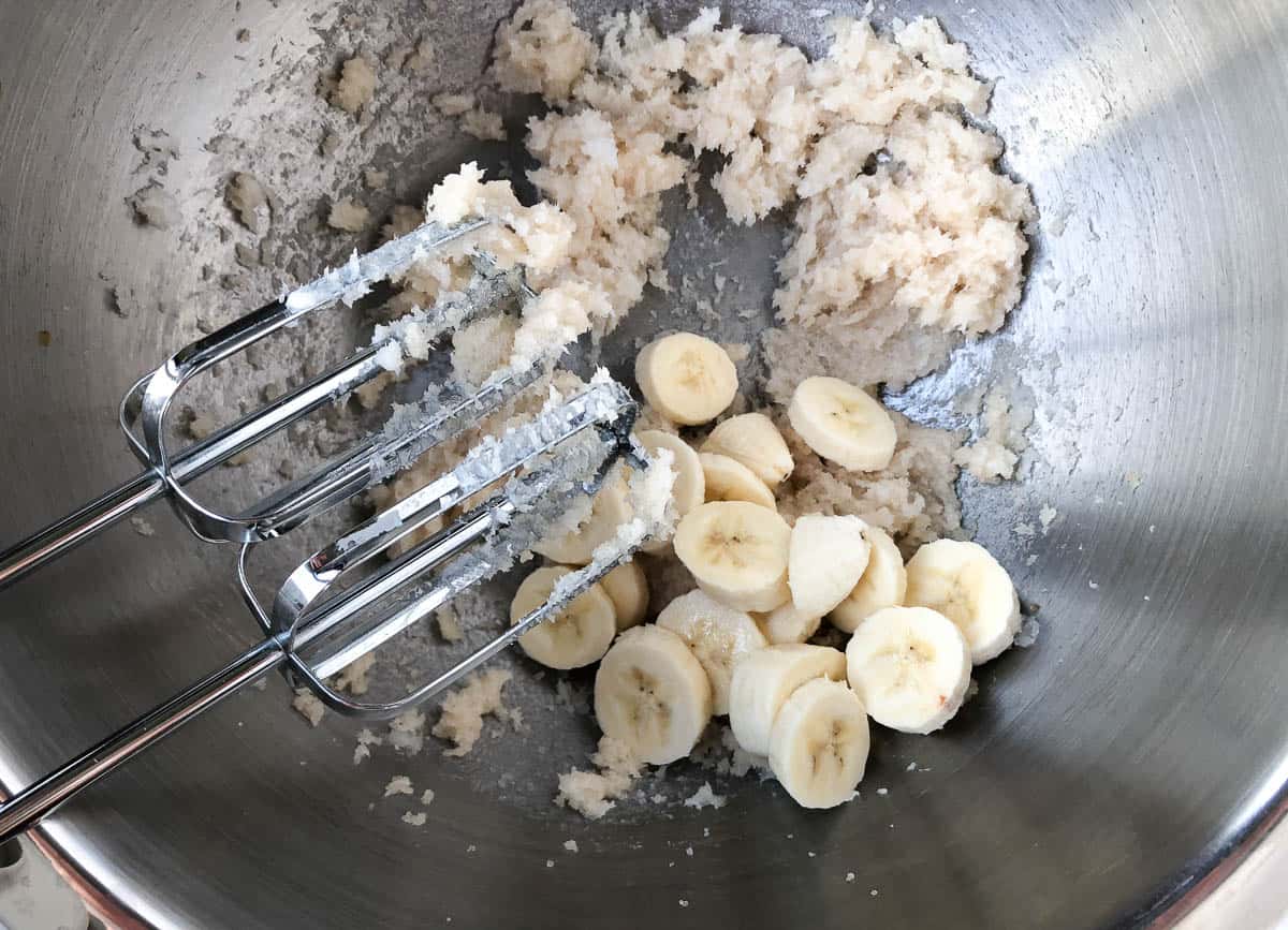 Adding chopped banana to cake batter.