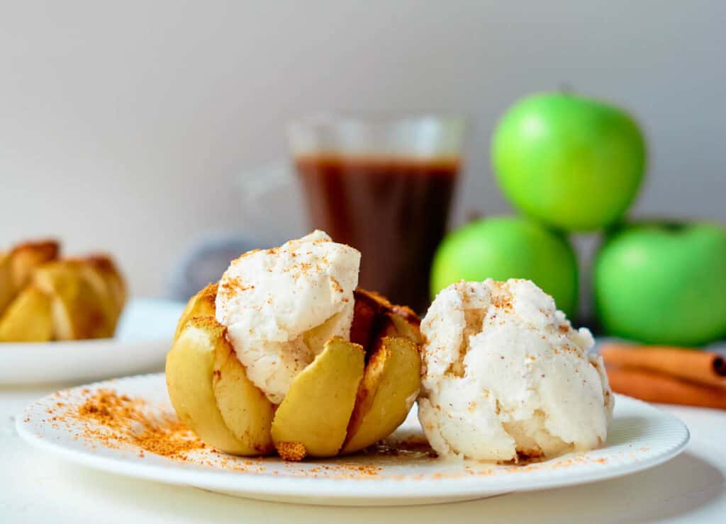 vegan baked apple with coffee and apples in the background
