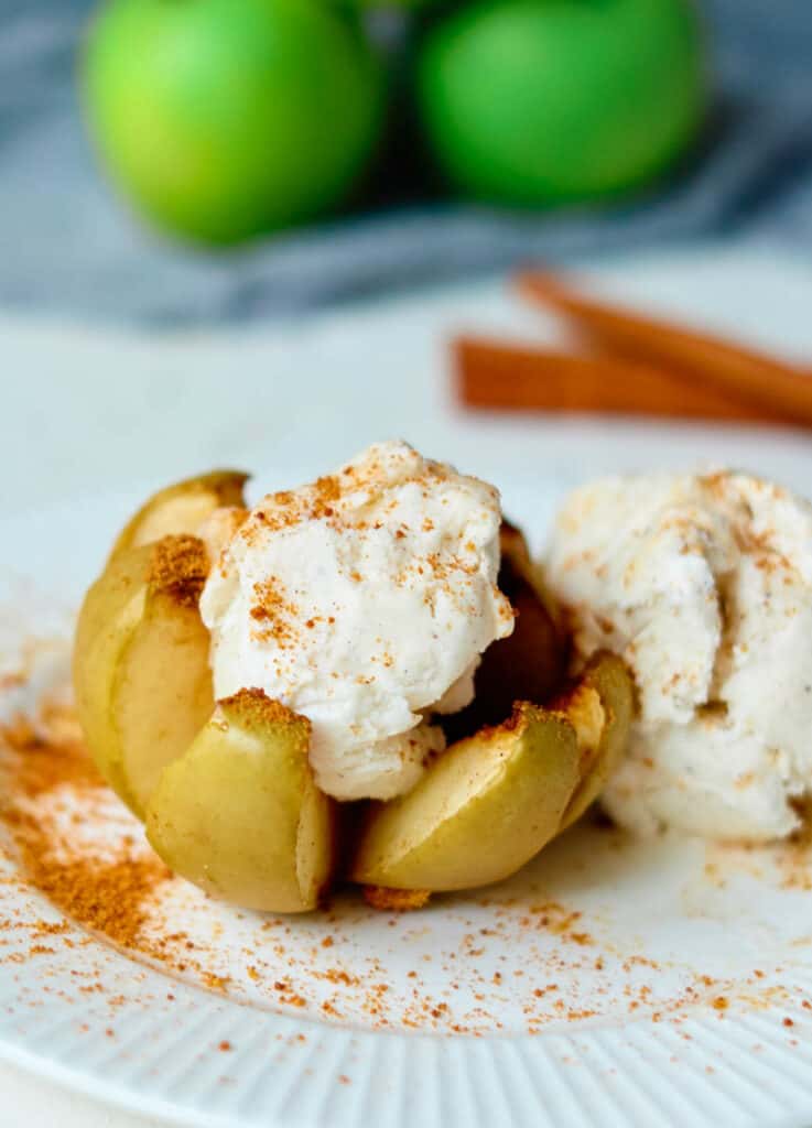 vegan baked apple blossom topped with cinnamon and coconut ice cream