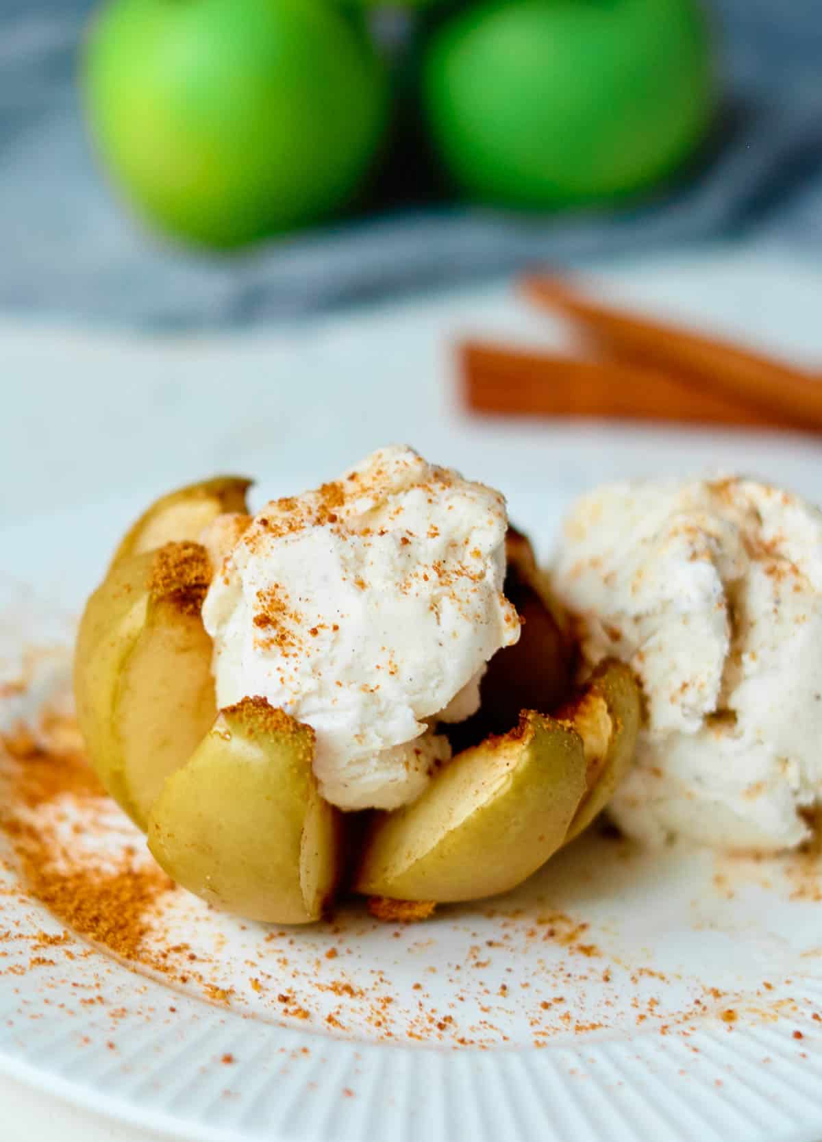 baked apple topped with ice cream and cinnamon