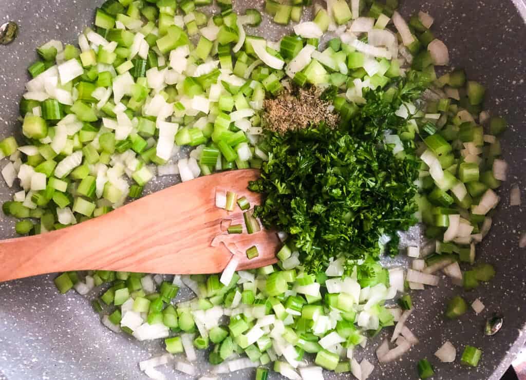 spices and parsley in pan with celery and onions