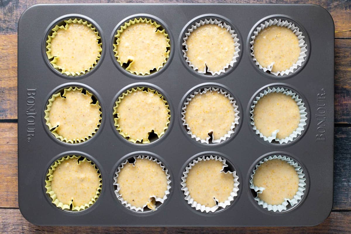 Corn muffin batter in muffin tin.