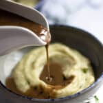 vegan gravy pouring on mashed potatoes