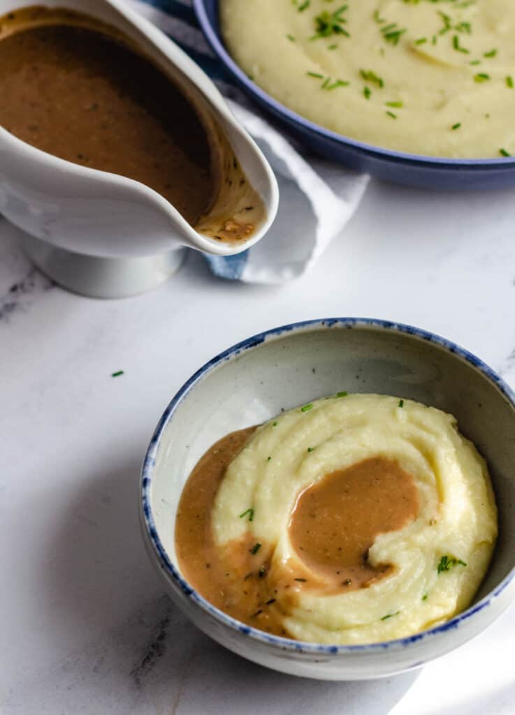 gravy on top of bowl of mashed potatoes