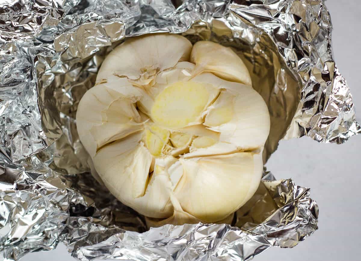 Garlic head wrapped in foil.
