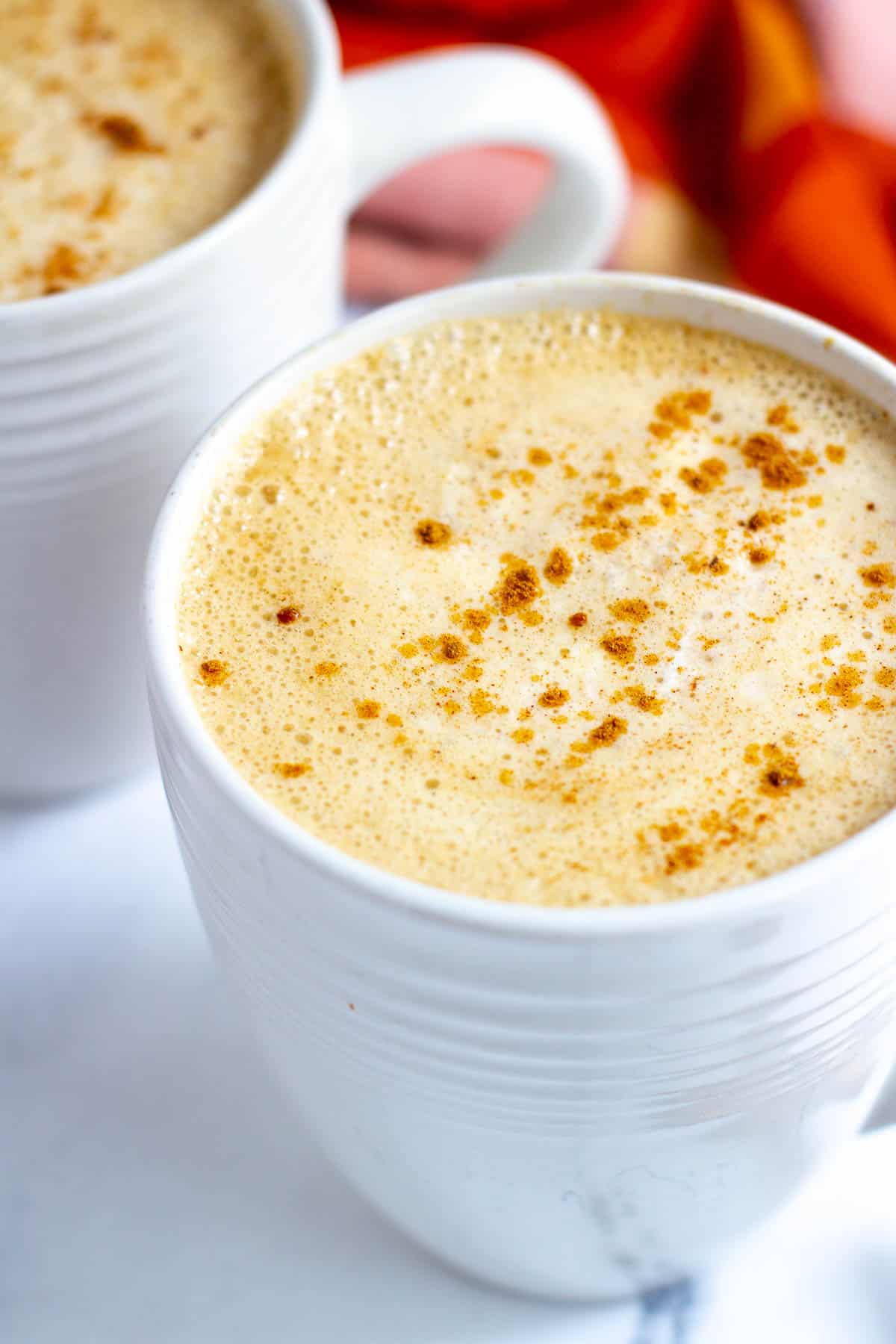 Pumpkin latte in white mug.