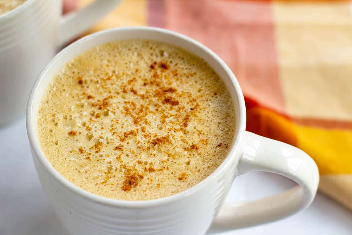 Vegan pumpkin spice latte in white mug.