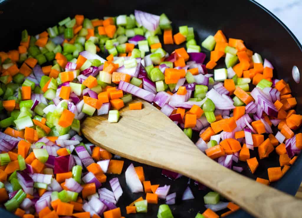 carrots, celery, and red onion in pan
